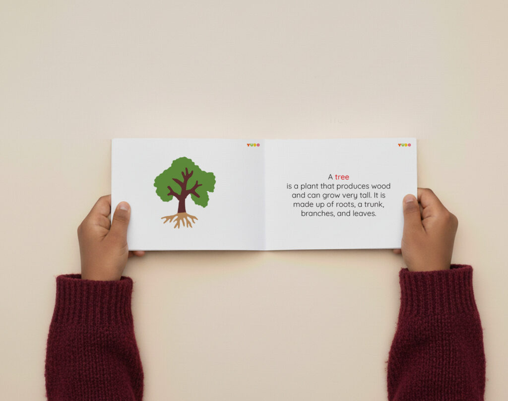 Child using a Montessori tree definition booklet with realistic tree illustration and simple scientific facts.